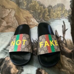 Gucci Black Slides with Signature Stripe and Bold Text